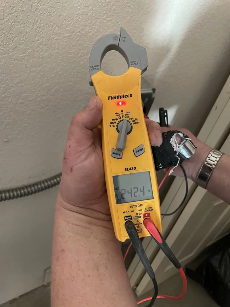 Voltage testing with clamp meter during Outlet Installation in Fairfax